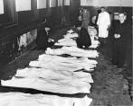 Bodies lie in the Cook County morgue awaiting identification. Descriptions of each body (hair color, clothing, jewelry) were recorded and compared to descriptions provided by parents so as to minimize the number of bodies they were forced to view while attempting to identify their beloved child.