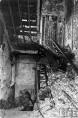 This is what is left of the northeast stairway where the fire started. The basement level where the fire began is down the stairs at left. The fire started directly below the stairway at right that leads up to the first floor. Note the partially open door on the first floor landing, at the top of the photo. That door prevented the fire from entering the first floor corridor as it did on second floor. Had there been a similar door on the second floor landing, no one would have been killed and the fire would have been just a minor footnote in history. (Life Magazine Photo)