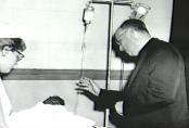 A priest blesses an injured child as he awaits treatment for his injuries. Hospital staffs were overwhelmed by the number of injured children and teachers pouring into their emergency wards.