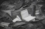 Books, book bags, notebooks and other classroom items lie among the rubble in room 208 where the destruction was severe, though not as severe as in room 210.