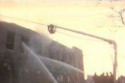 Firemen are beginning to win the battle as the snorkel directs water onto the burning roof and firemen on the ground shoot water through the windows into room 210.