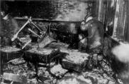 Firemen dig through the rubble in room 211 on the evening of the fire. This room overlooks the small courtyard between the north and south wings of the school. Twenty-four children died in this room just hours before this picture was taken. This classroom was the only one in which many students died but the teacher did not.