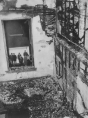 The stairwell (as seen from the second floor hallway) where the fire was worst. The fire started at the foot of this stairwell, two floors below, in the basement. Onlookers can be seen through the window standing in the alley north of the school.